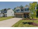 Beautiful two-story home with a well-manicured lawn and a driveway at 2586 Lacey Holt Rd, Graham, NC 27253