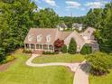 Expansive aerial view showcasing a home's lush green lawn, inviting walkway, and a detached garage at 2945 Chimney Hill Trl, Rocky Mount, NC 27804