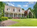 Inviting front porch with classic columns, brick steps, and meticulously maintained landscaping at 2945 Chimney Hill Trl, Rocky Mount, NC 27804