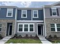 Charming townhouse exterior showcasing a mix of siding and brick, complemented by landscaped greenery at 3010 Fulong Dr, Durham, NC 27704