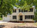 Inviting two-story home featuring black shutters, a covered entrance, and attached garage at 308 Fleming Dr, Durham, NC 27712