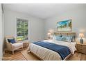 Relaxing bedroom featuring beach-themed decor, a cozy chair, and ample natural light at 308 Plaza Dr, Garner, NC 27529