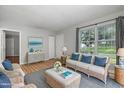 Bright living room with coastal decor, comfortable seating, and natural light, creating a relaxing atmosphere at 308 Plaza Dr, Garner, NC 27529
