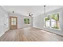 Bright living room showcasing hardwood floors, modern lighting, and large windows offering abundant natural light at 313 W Murray Ave, Durham, NC 27704