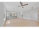 Open-concept living room featuring hardwood floors, recessed lighting, ceiling fan, and a large kitchen island at 313 W Murray Ave, Durham, NC 27704