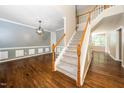 Inviting foyer with hardwood floors, staircase, and decorative lighting at 316 Academia Ct, Durham, NC 27713