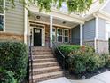 Inviting front porch featuring brick steps and tasteful landscaping, enhancing curb appeal at 354 Crimson Way, Pittsboro, NC 27312