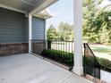 This outdoor porch shows the backyard with a wrought iron railing around the perimeter at 354 Crimson Way, Pittsboro, NC 27312