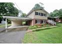 Charming home with a convenient carport, showcasing a blend of brick, siding, and a well-manicured lawn at 3812 Vesta Dr, Raleigh, NC 27603