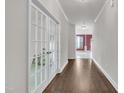 Hallway featuring hardwood floors, a view through French doors, and recessed lighting at 428 Mill Station Ln, Wendell, NC 27591