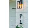 Close up of home address next to carriage lights, adding a touch of modern elegance to the exterior at 4349 Pickwick Dr, Raleigh, NC 27613