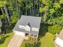 Aerial view of a two-story home surrounded by mature trees and a landscaped yard at 4600 Landover Dale Dr, Raleigh, NC 27616