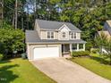 Traditional two-story home featuring an attached garage, and lush green lawn at 4600 Landover Dale Dr, Raleigh, NC 27616