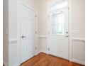 Inviting foyer with a decorative glass door and hardwood flooring at 4622 Ivy Blossom Ln, Raleigh, NC 27604
