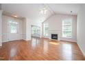 Bright living room features a fireplace, ceiling fan, and gleaming hardwood floors at 4622 Ivy Blossom Ln, Raleigh, NC 27604