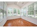 Sunroom with many windows offering natural light and hardwood flooring at 4622 Ivy Blossom Ln, Raleigh, NC 27604