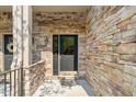 Close up of entrance door #202 with stone exterior and black door at 4831 Crestmore Rd # 202, Raleigh, NC 27612