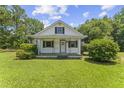 Charming one-and-one-half story home featuring a cozy front porch and lush green lawn at 4880 Old Us Hwy 64, Zebulon, NC 27597