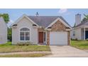 Charming home featuring stone accents, a well-maintained lawn, and an attached single car garage at 5000 Mocha Ln, Raleigh, NC 27616