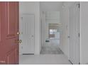 Bright foyer with white floors and a view into the living room at 5000 Mocha Ln, Raleigh, NC 27616