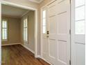 Bright foyer featuring a white front door with sidelights and hardwood-style floors at 505 Commander Dr, Wendell, NC 27591