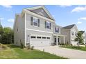 Beautiful two-story home with a two car garage, well-maintained lawn, and a modern design at 544 Tanner Lake Ln, Raleigh, NC 27610