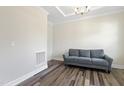 Well-lit living room with hardwood floors, crown molding, and a comfortable sofa for relaxing and entertaining at 544 Tanner Lake Ln, Raleigh, NC 27610