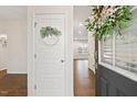 Bright entryway featuring wood floors, a decorative wreath, and a glimpse into the home's open layout at 553 Sturgeon St, Smithfield, NC 27577