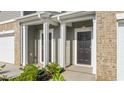 Inviting townhome entrance with columns and tidy landscaping at 5560 Henley Ridge Dr # 187, Graham, NC 27253