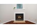 Close up of a living room fireplace with tiled hearth and mantlepiece at 6016 Farm Gate Rd, Raleigh, NC 27606