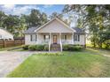 Charming home featuring a covered front porch, manicured lawn, and inviting curb appeal at 609 N Country Club Dr, Oxford, NC 27565