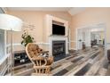 Cozy living room with a fireplace, mounted television, and unique wood flooring at 609 N Country Club Dr, Oxford, NC 27565