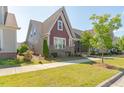 Beautiful home showcasing well-maintained landscaping and vibrant green lawn in a sunny neighborhood at 6612 Enrichment Ln, Raleigh, NC 27616