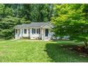 Charming home with well-maintained lawn and inviting porch, perfect for relaxing outdoors at 725 E Maple Ln, Fuquay Varina, NC 27526