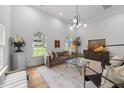 Bright living room features hardwood floors, many windows, high ceilings, and stylish decor at 807 Edmund St, Raleigh, NC 27604