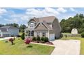 Well-maintained home boasts an attached garage and long driveway at 85 Twelve Oaks Dr, Willow Springs, NC 27592