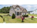 Beautiful two-story home with a covered front porch and stone accents at 85 Twelve Oaks Dr, Willow Springs, NC 27592