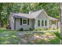 Charming single story home featuring a gray painted brick and siding exterior with a mature landscaped yard at 908 Snow Hill Rd, Durham, NC 27712