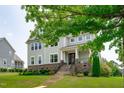 Charming two-story home with stone accents, manicured lawn, and inviting front porch at 909 Green Oaks Pkwy, Holly Springs, NC 27540