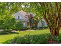 Charming home featuring stone accents, manicured lawn, and mature trees for enhanced curb appeal at 102 Bosswood Ct, Cary, NC 27518