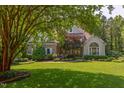 Charming home featuring stone accents, manicured lawn, and mature trees for enhanced curb appeal at 102 Bosswood Ct, Cary, NC 27518