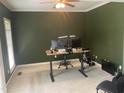 Office space with light carpet, green walls, crown molding, and a ceiling fan at 104 Belle Isle Ct, Cary, NC 27513