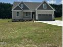 Charming one-story home featuring a two-car garage and a covered front porch at 106 Viola Ln, Franklinton, NC 27525