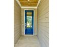 A stylish blue front door with glass inset, and stained wood porch ceiling at 106 Viola Ln, Franklinton, NC 27525