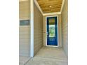 A stylish blue front door with glass inset, number plaque and stained wood porch ceiling at 106 Viola Ln, Franklinton, NC 27525
