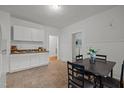 Bright kitchen with white cabinets, and a dining area with a table and four chairs at 1108 Taylor Street, Durham, NC 27701