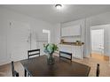 Kitchen and dining area with refrigerator, modern cabinets and a window for natural light at 1108 Taylor Street, Durham, NC 27701
