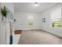 Bright living room featuring neutral carpet, fresh paint, and two well-lit windows at 1108 Taylor Street, Durham, NC 27701
