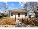 Charming single-story home with a welcoming front porch, steps, and neat landscaping at 112 Edgewood Dr, Roxboro, NC 27573