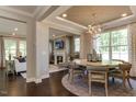 Open-concept dining area showcasing elegant lighting and sightlines into living room and fireplace at 1221 Coral Cay Bnd, Wake Forest, NC 27587
